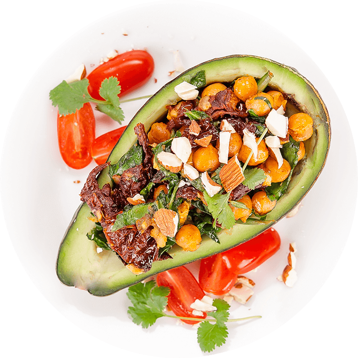Stuffed avocado with chickpeas, spinach and dried tomatoes