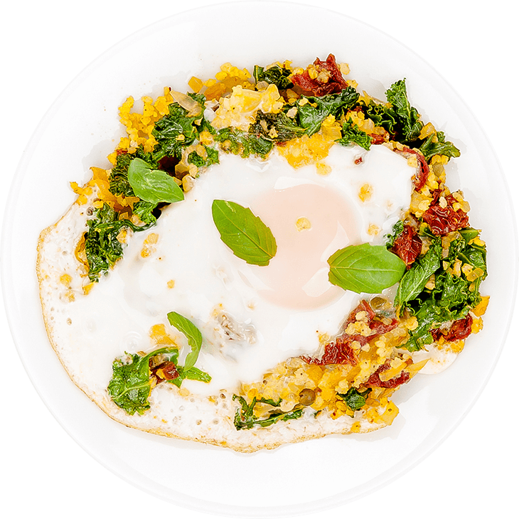 Fried eggs on millet and kale