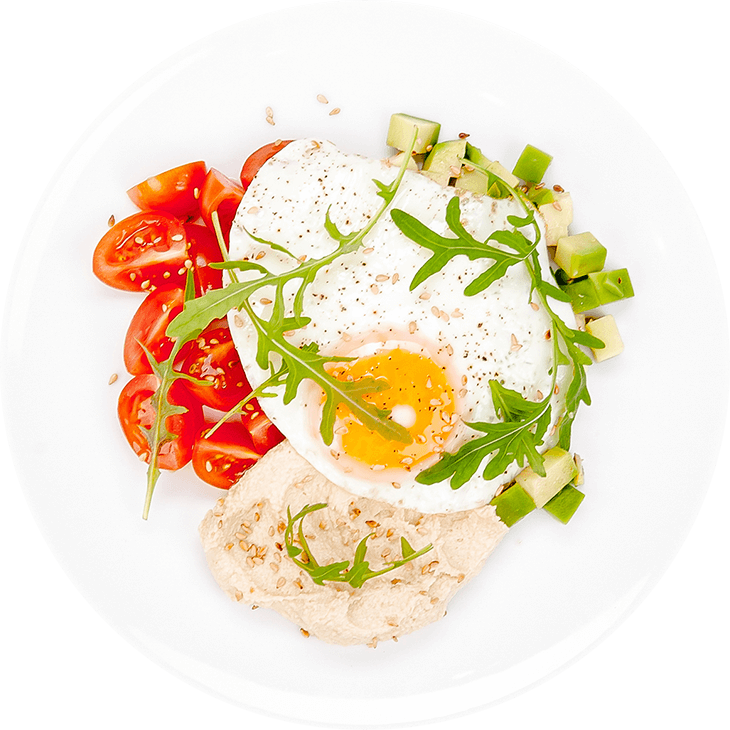 Fried eggs with hummus and avocado