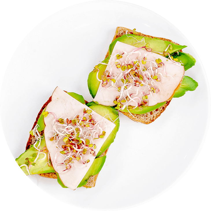 Sandwich with ham, avocado and sprouts