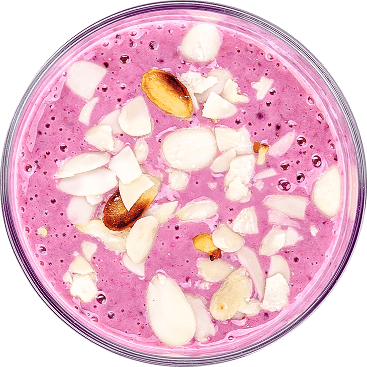 Smoothie with forest fruit, banana and almond flakes